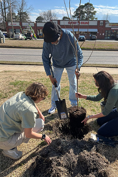 Virginia Wesleyan University students and community members planting native trees in Portsmouth.